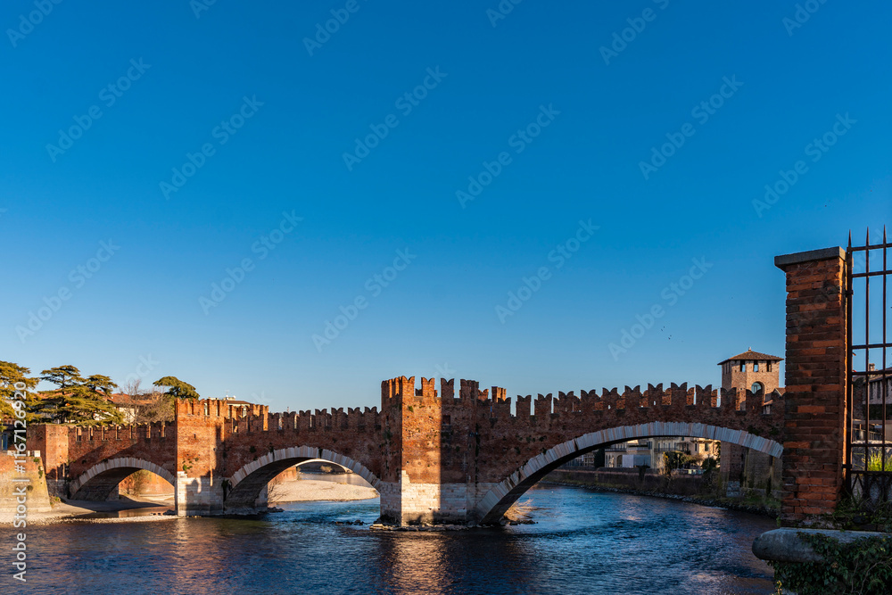 Naklejka premium panorama of medieval scaligero castelvecchio bridge over adige river, verona, italy - world travel concept