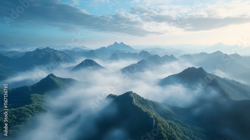 Aerial view of misty mountains with rolling fog, morning sunlight, and blue sky, creating an ethereal, dreamy landscape with cinematic lighting. photo