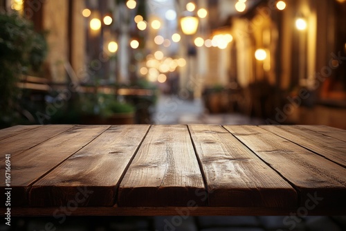Rustic wooden table in a warmly lit outdoor caf setting during evening hours