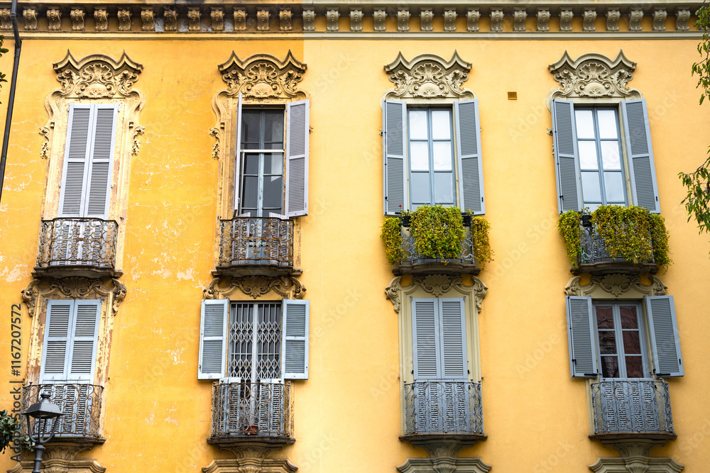 Facade of old yellow building with shuttered windows Facade of old yellow building with shuttered windows