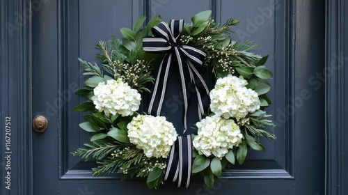 Beautiful floral wreath with white hydrangeas and greenery on a dark blue door