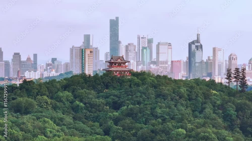 Skyline view of urban architecture contrasting with lush hills and historical structure in a vibrant cityscape Skyline view of urban architecture contrasting with lush hills and historical structure in a vibrant cityscape