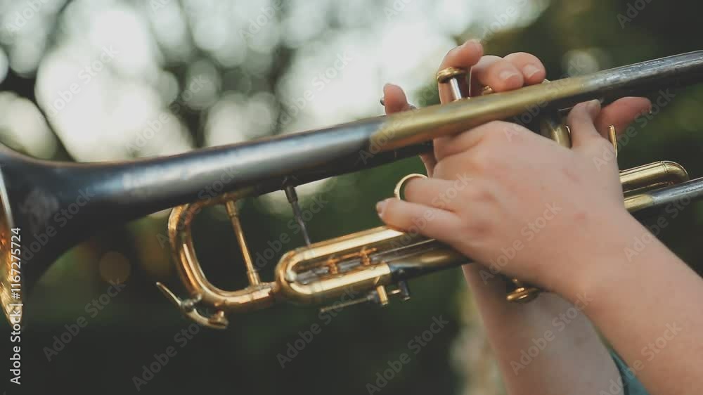 jazz band playing on the street, selective focus on the hands with trumpet