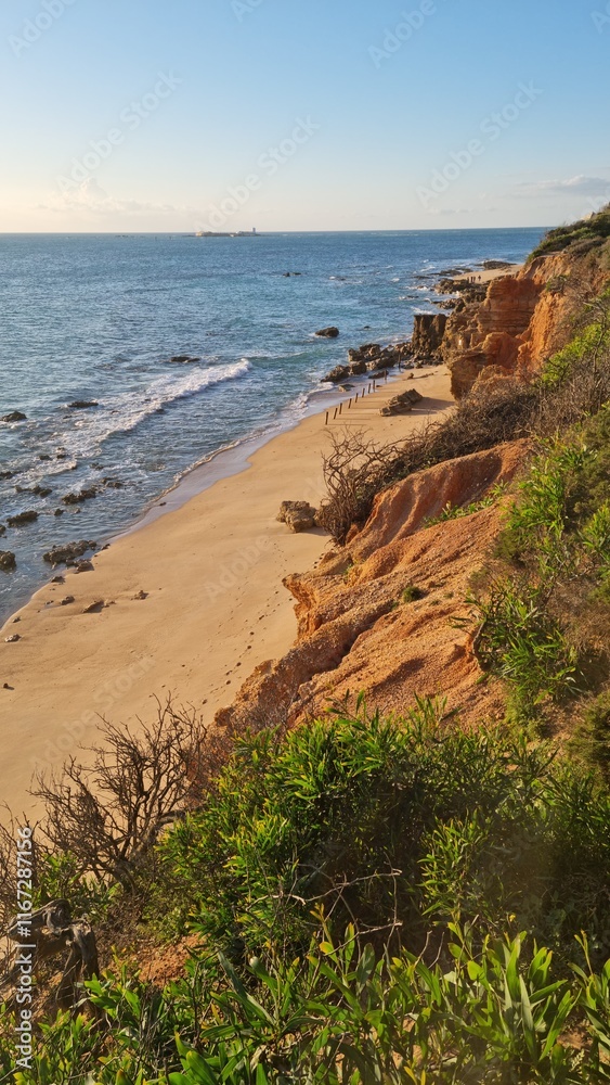 incredible view of the rocks and the ocean. sandy beach in the sun and sea stones. surf and foamy waves incredible view of the rocks and the ocean. sandy beach in the sun and sea stones. surf and foamy waves