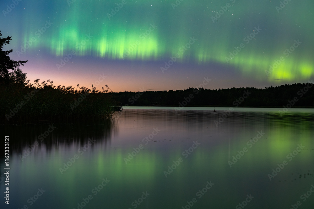 Aurora Borealis Nothern Lights reflected in a lake Aurora Borealis Nothern Lights reflected in a lake