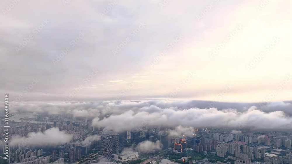 Stunning aerial view of a city skyline under a blanket of clouds at sunset from a high vantage point Stunning aerial view of a city skyline under a blanket of clouds at sunset from a high vantage point
