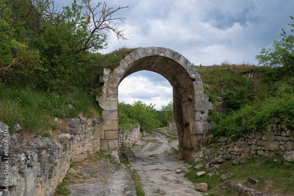 Orta-Kapu Gate (Northern Gate) of the ancient fortress Chufut-Kale on a cloudy May day Crimea Orta-Kapu Gate (Northern Gate) of the ancient fortress Chufut-Kale on a cloudy May day Crimea
