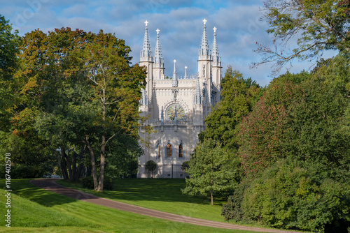 The ancient chapel of St. Prince Alexander Nevsky in a sunny September landscape. Alexandria Park, Peterhof. Suburbs of St. Petersburg, Russia photo