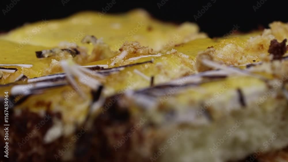 Close-up of a layered cake rotating, topped with edible decorations. Close-up of a layered cake rotating, topped with edible decorations.