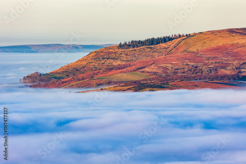 Fog filled valleys and mountain peaks at dusk (Brecon Beacons, Wales) photo