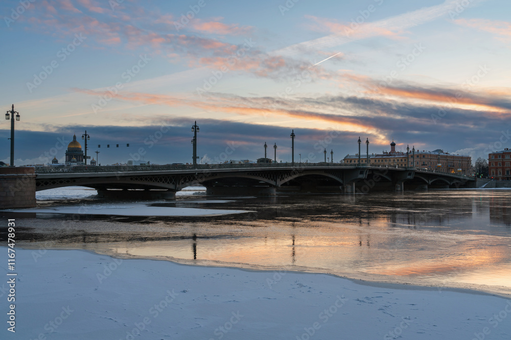 View of the Annunciation Bridge over the Neva River and St. Isaac's Cathedral against the background of the dawn sky on a winter morning, St. Petersburg, Russia View of the Annunciation Bridge over the Neva River and St. Isaac's Cathedral against the background of the dawn sky on a winter morning, St. Petersburg, Russia