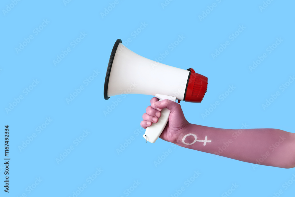 Woman with painted hand holding megaphone on blue background. Feminism concept Woman with painted hand holding megaphone on blue background. Feminism concept