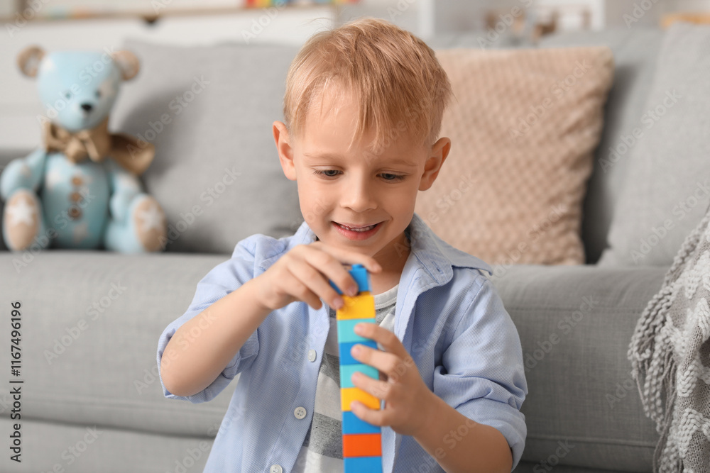 Happy cute little boy building tower with colorful toy bricks at home Happy cute little boy building tower with colorful toy bricks at home