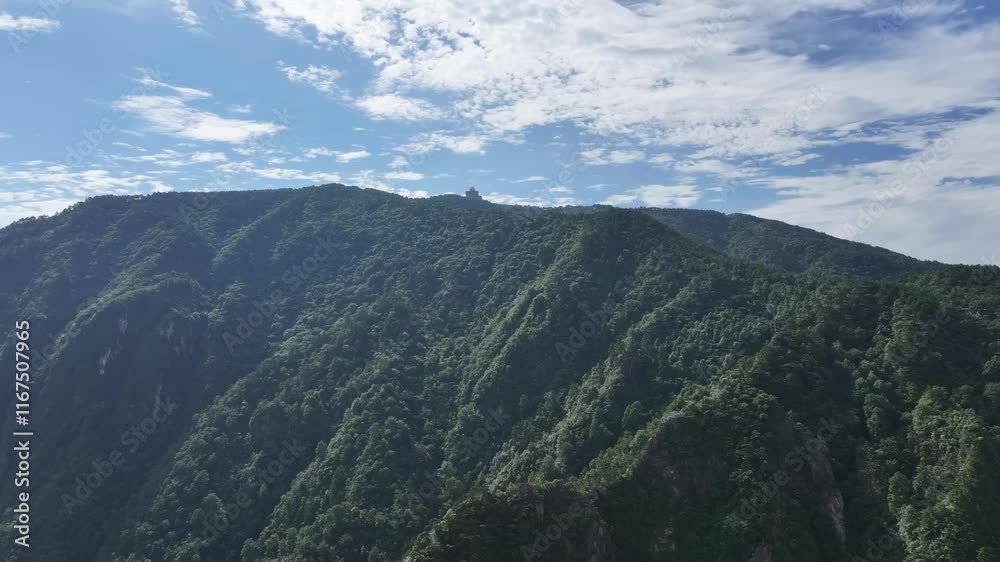 Majestic mountain range showcasing lush greenery and clear blue skies under bright sunlight Majestic mountain range showcasing lush greenery and clear blue skies under bright sunlight