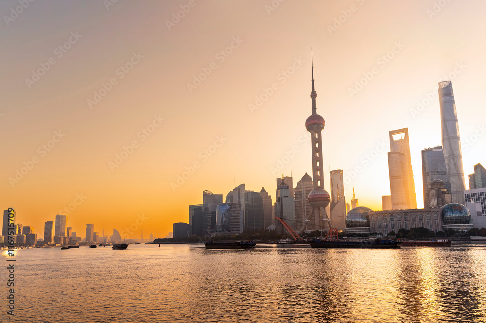 Shanghai city modern skyscraper cityscape and red maple foreground in blue sky autumn season behind pollution haze, view from the bund in Shanghai, China.