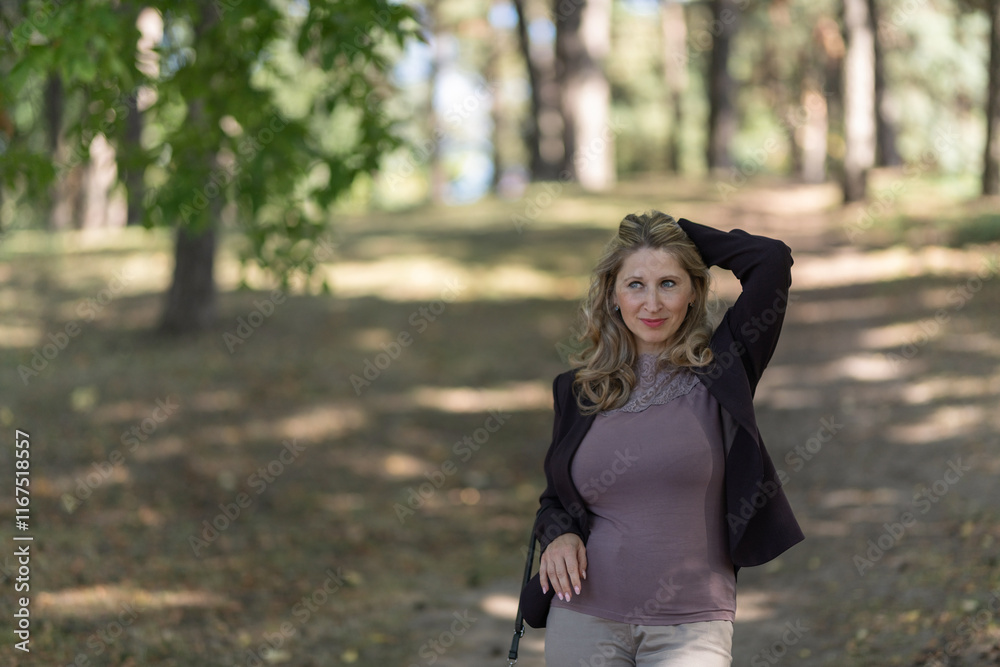 Portrait of a beautiful blonde young girl in a summer city park. Portrait of a beautiful blonde young girl in a summer city park.
