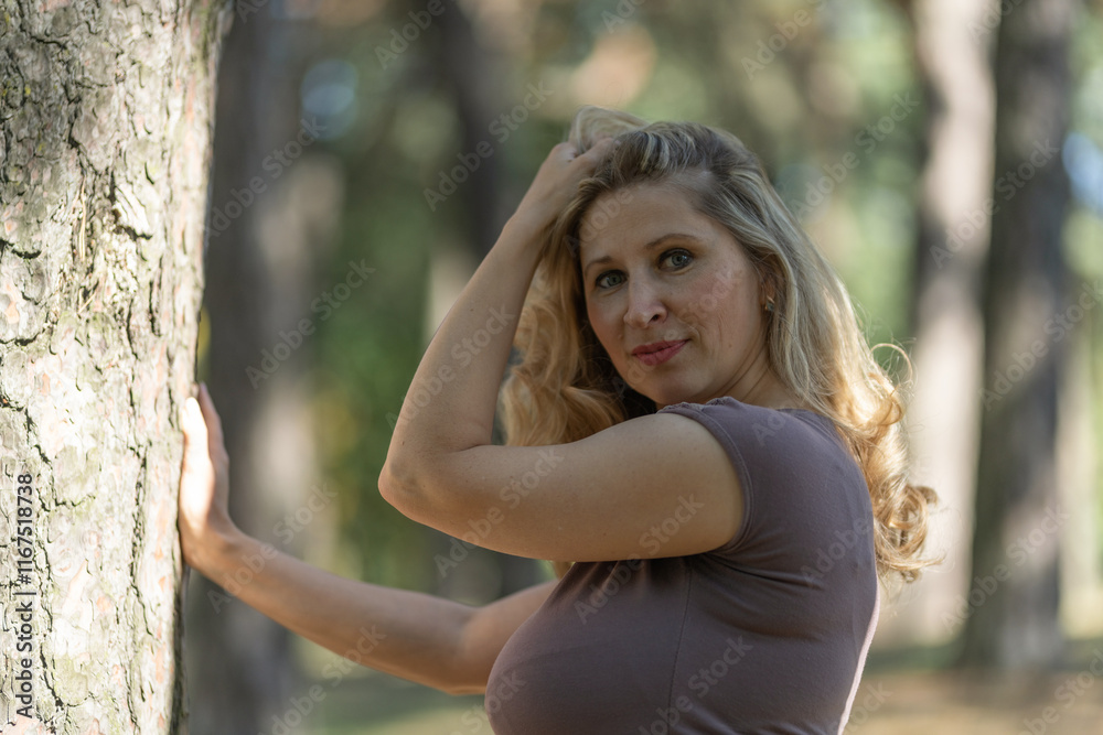 Portrait of a beautiful blonde young girl in a summer city park. Portrait of a beautiful blonde young girl in a summer city park.