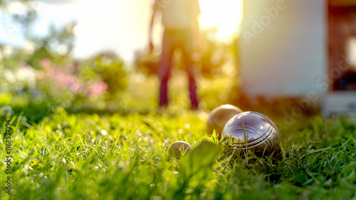 elderly people playing petanque on green grass photo