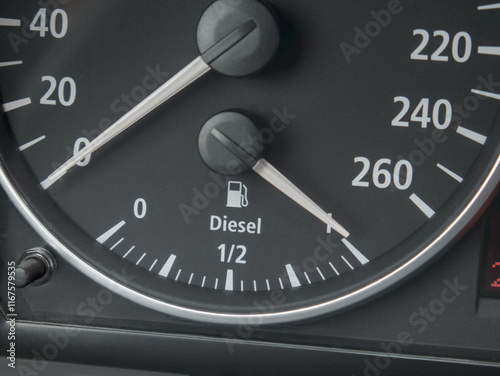 A close-up shot of a car's dashboard gauge showing an overflowing diesel fuel tank photo