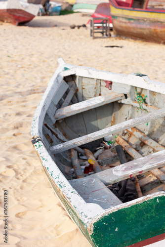 Old fish boat on the sand