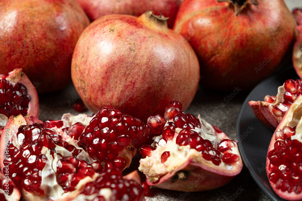 Ripe pomegranates, peeled and whole, the concept of benefits and vitamins in fruit. Ripe pomegranates, peeled and whole, the concept of benefits and vitamins in fruit.