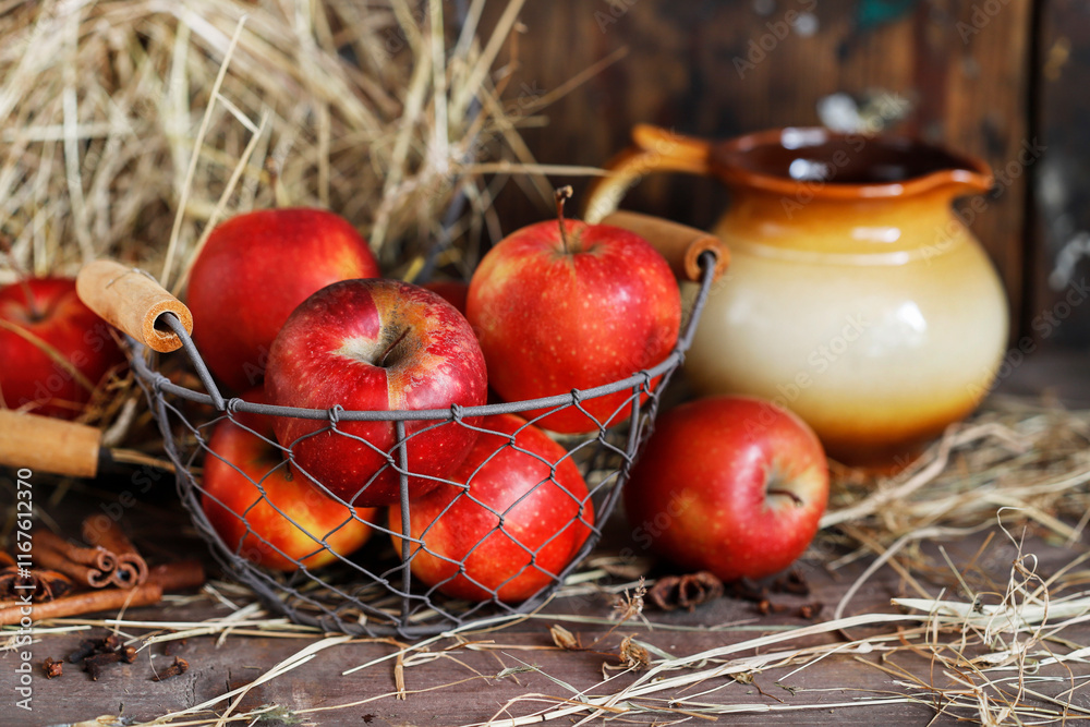 Red apples in wicker basket, wooden background.