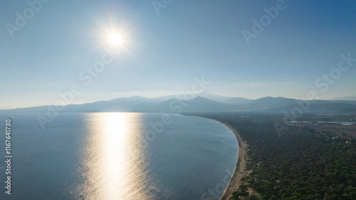 Sun over Schinias beach and the Aegean sea, Greece photo