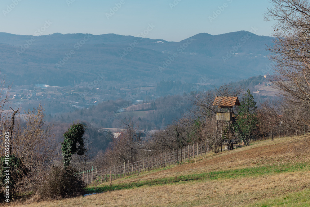 Epic early winter view of hunters lookout from away, visible lookout and great panorama of the dolenjska region valley in slovenia..