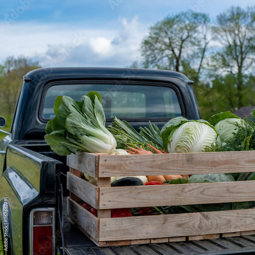 Classic old pickup truck loaded with tiny family farm produce for farmers market blue sky nostalgic vibe in small town USA photo