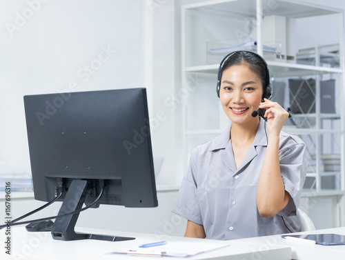 Portrait of Asian businesswoman with a headset, working on customer care and Customer service representative in office. Happy asian call center woman helpdesk looking at camera with a smiling face.