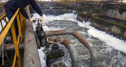 Old water treatment plant shows operations with valves and flowing water during maintenance activities