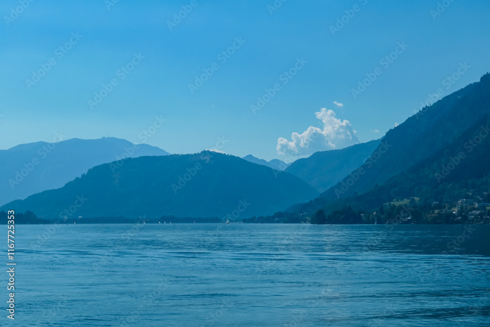 Breathtaking view of Lake Ossiach surrounded by majestic mountain Dobratsch and rolling hills of Ossiacher Tauern in Carinthia, Austria, Europe. Serene and idyllic scene in Austrian Alps in summer Breathtaking view of Lake Ossiach surrounded by majestic mountain Dobratsch and rolling hills of Ossiacher Tauern in Carinthia, Austria, Europe. Serene and idyllic scene in Austrian Alps in summer