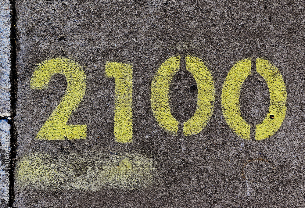Number 2100 painted with spray paint on street concrete