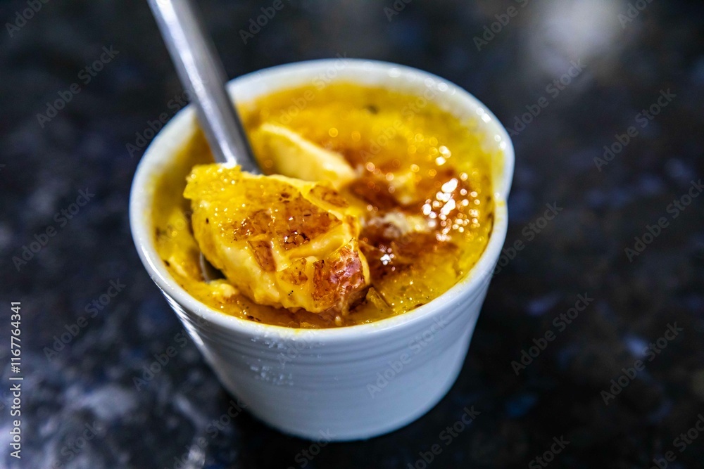Crème brûlée, creme brule. Classic creme brulé being flambé. Burning, flaming, ramekins, vanilla beans, blowtorch, sugar Crème brûlée, creme brule. Classic creme brulé being flambé. Burning, flaming, ramekins, vanilla beans, blowtorch, sugar