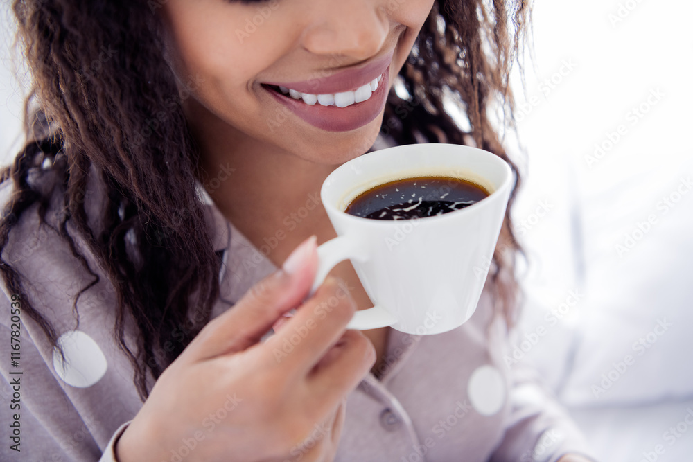 Young woman enjoying a morning coffee in comfortable sleepwear with a joyful smile Young woman enjoying a morning coffee in comfortable sleepwear with a joyful smile