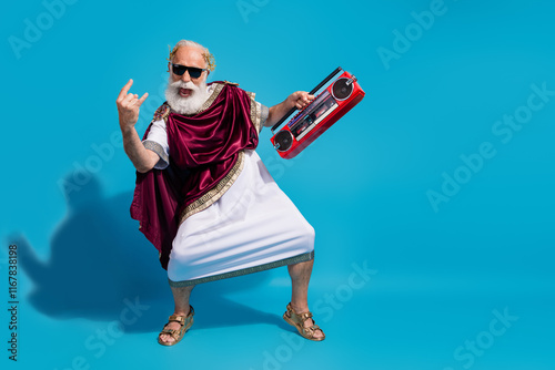 Photo of crazy cheerful man roman culture traditional clothes enjoy cool party isolated on blue color background photo