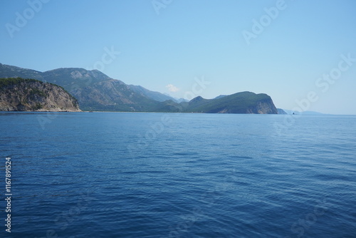 RT Dubovica Rocks near Buljarica and Svetac Rock, Montenegro. Stones, inaccessible rocks. Flysch marine lithological layers. Adriatic Mediterranean sea blue water. Nature park Katici. District Budva photo