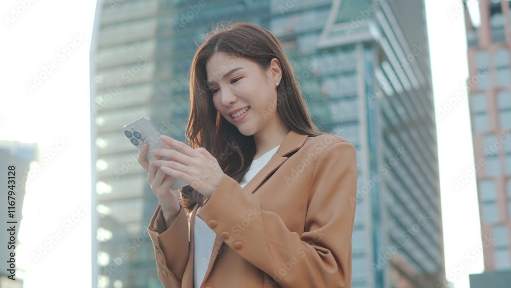 Asian Confident Business woman smiling at the camera and enjoying outdoor city life with calm demeanor and style ,Remote work. Relax businesswoman in modern city sunny day urbans outdoors