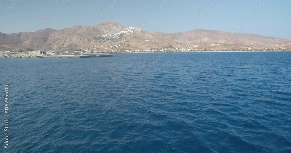 Handheld shot view from a boat, tilt up to reveal a Cycladic island. Serifos island of the Cyclades, Greece. Handheld shot view from a boat, tilt up to reveal a Cycladic island. Serifos island of the Cyclades, Greece.