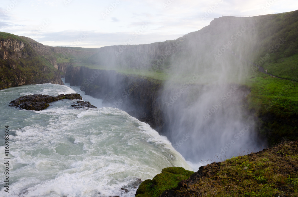 Gullfoss Waterfall, part of Iceland's golden circle route shimmers in deep blue as the icy water plunges into the gorge under dramatic skies Gullfoss Waterfall, part of Iceland's golden circle route shimmers in deep blue as the icy water plunges into the gorge under dramatic skies