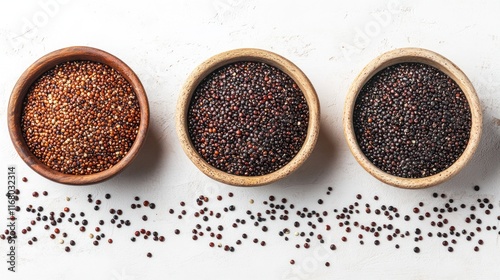 Three bowls of red, black, and tri-color quinoa seeds.