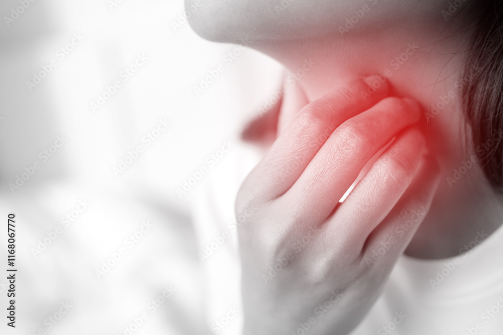 Naklejka premium sore throat pain. Closeup of young woman sick holding her inflamed throat using hands to touch the ill neck in blue shirt on gray background. Medical and healthcare concept.