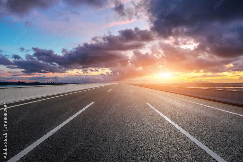 Straight highway road and coastline with beautiful sky clouds nature landscape at sunset. Outdoor road background.