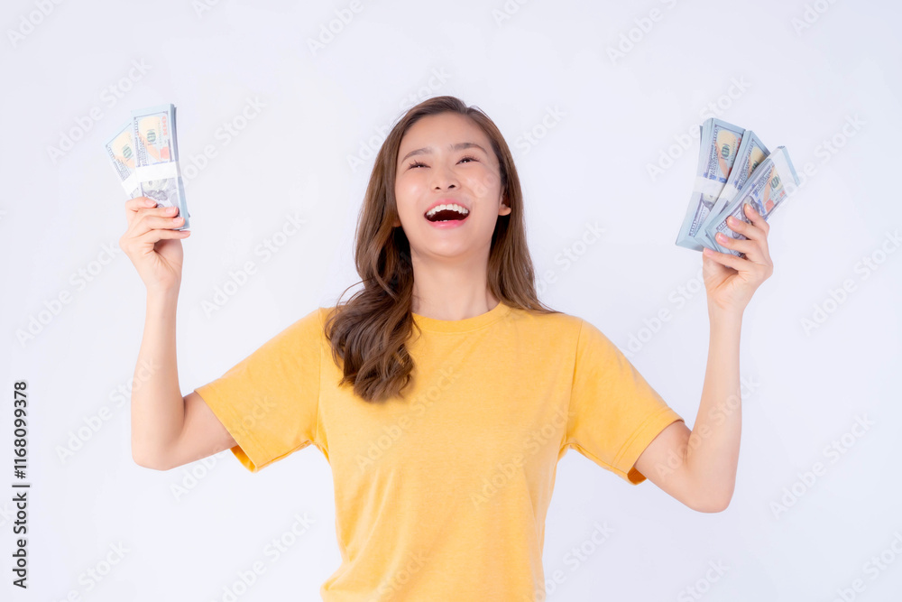Beautiful Excited Asian Woman Holding Multiple Stacks of Dollar Bills in Both Hands, Wearing Casual Yellow T-Shirt, Celebrating Financial Success and Wealth, Isolated on White Background Beautiful Excited Asian Woman Holding Multiple Stacks of Dollar Bills in Both Hands, Wearing Casual Yellow T-Shirt, Celebrating Financial Success and Wealth, Isolated on White Background