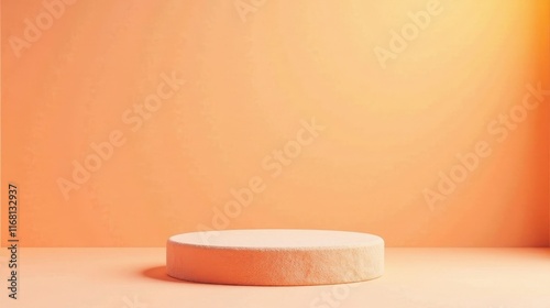 A simple, minimalist peach-colored cylindrical platform rests on a matching surface against a muted orange wall, providing a clean and elegant backdrop for product displays or artistic arrangements.