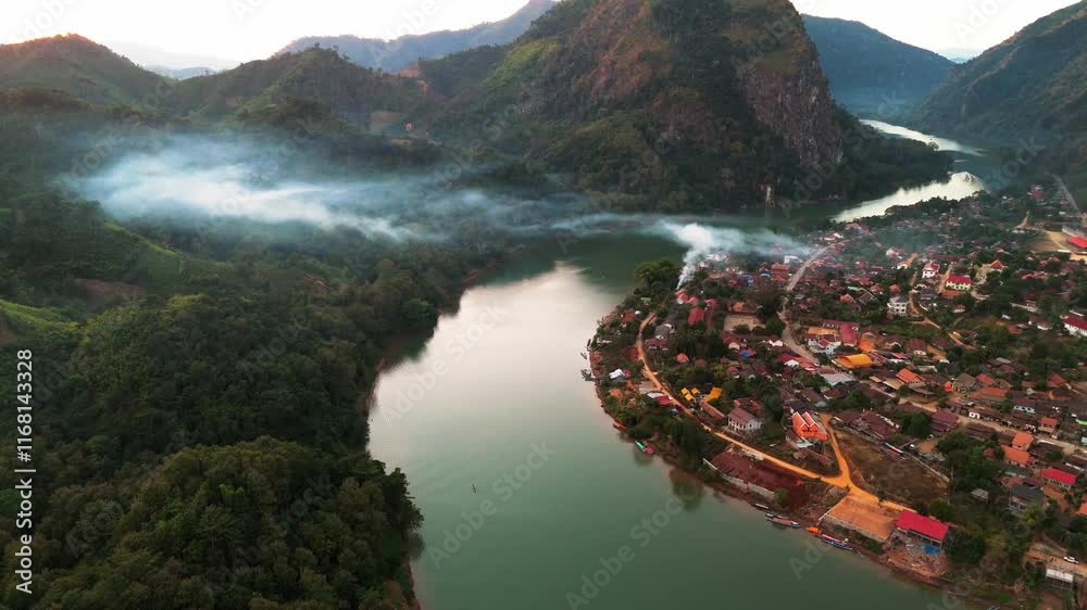 aerial sunset view of Nong Khiaw village in the Luang Prabang Province of northern Laos on the Nam Ou River drone footage travel destination south east Asia 