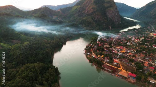 aerial sunset view of Nong Khiaw village in the Luang Prabang Province of northern Laos on the Nam Ou River drone footage travel destination south east Asia 