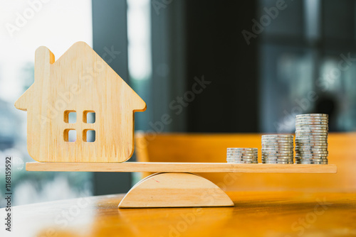 Wood house and Coins stack with balance scale. Money management, financial plan, time value of money. Real estate and property agent offer house concepts. photo