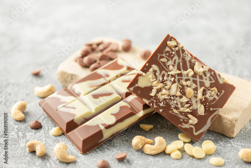 Homemade white milk bar chocolate with cashew nuts on the table photo