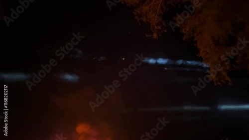 Festive beach footage capturing New Year’s celebration with fireworks lighting up the night sky. People gather in joy, enjoying the festive atmosphere.